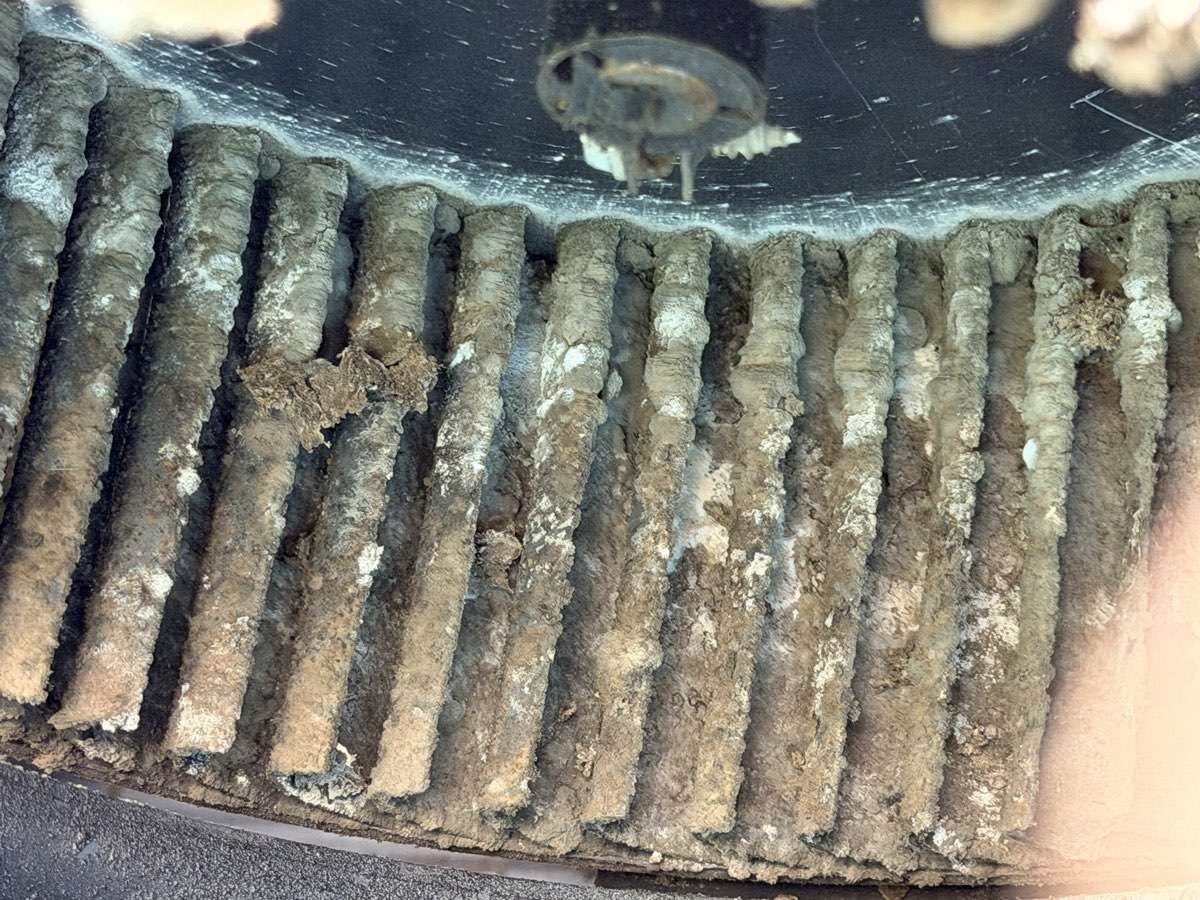 RV air conditioner blower fins before cleaning — caked with built-up grime
